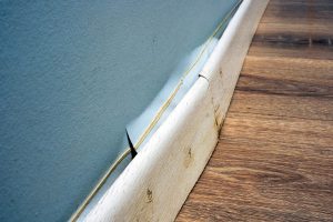 Swollen baseboards is a commun sign of water damage